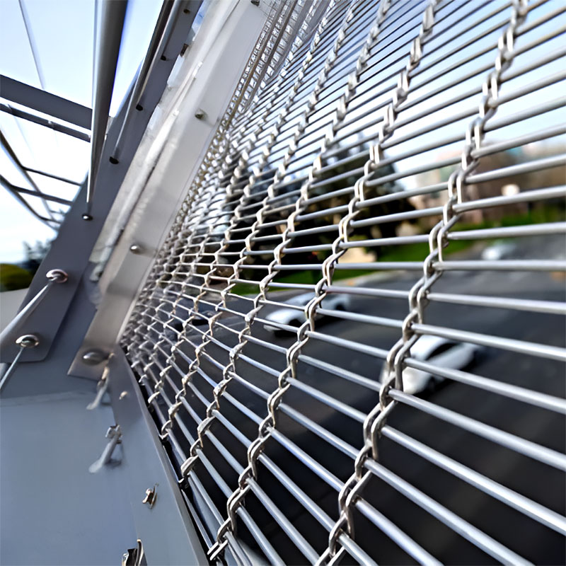 Woven wire drapery curtain panel made of decorative metal mesh used as a modern room divider or wall covering in architectural design.