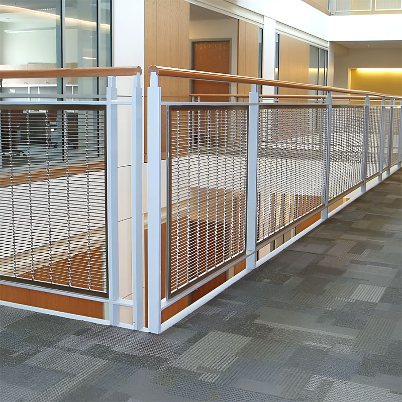 Woven wire drapery curtain panel made of decorative metal mesh used as a modern room divider or wall covering in architectural design.