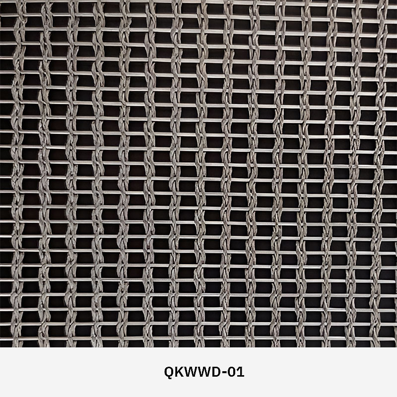 Woven wire drapery curtain panel made of decorative metal mesh used as a modern room divider or wall covering in architectural design.