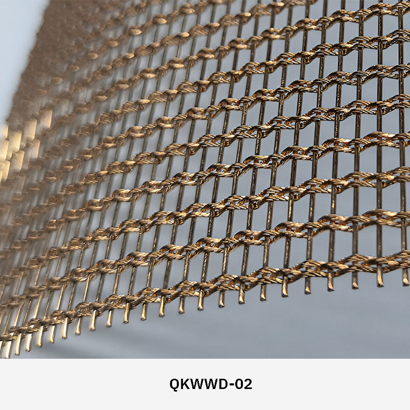 Woven wire drapery curtain panel made of decorative metal mesh used as a modern room divider or wall covering in architectural design.