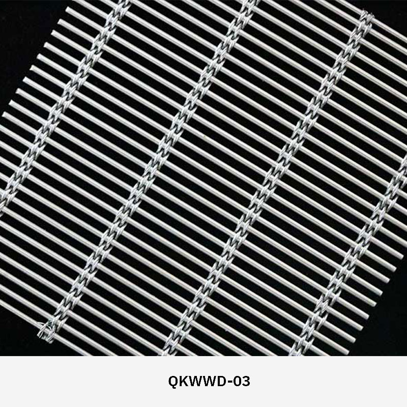Woven wire drapery curtain panel made of decorative metal mesh used as a modern room divider or wall covering in architectural design.