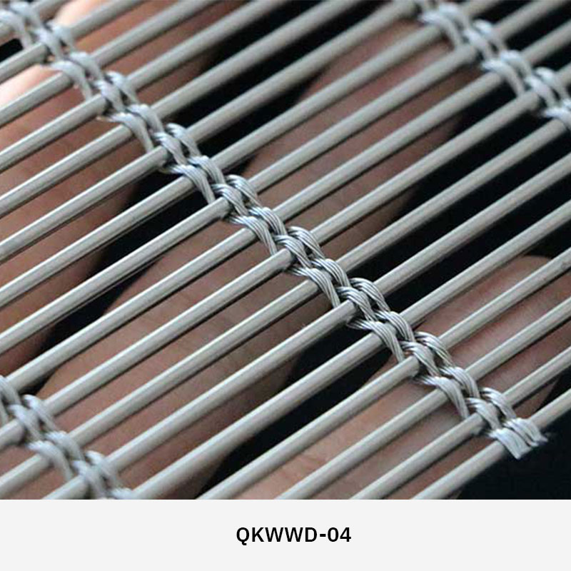 Woven wire drapery curtain panel made of decorative metal mesh used as a modern room divider or wall covering in architectural design.