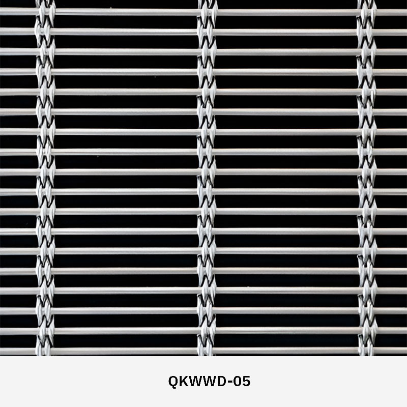 Woven wire drapery curtain panel made of decorative metal mesh used as a modern room divider or wall covering in architectural design.