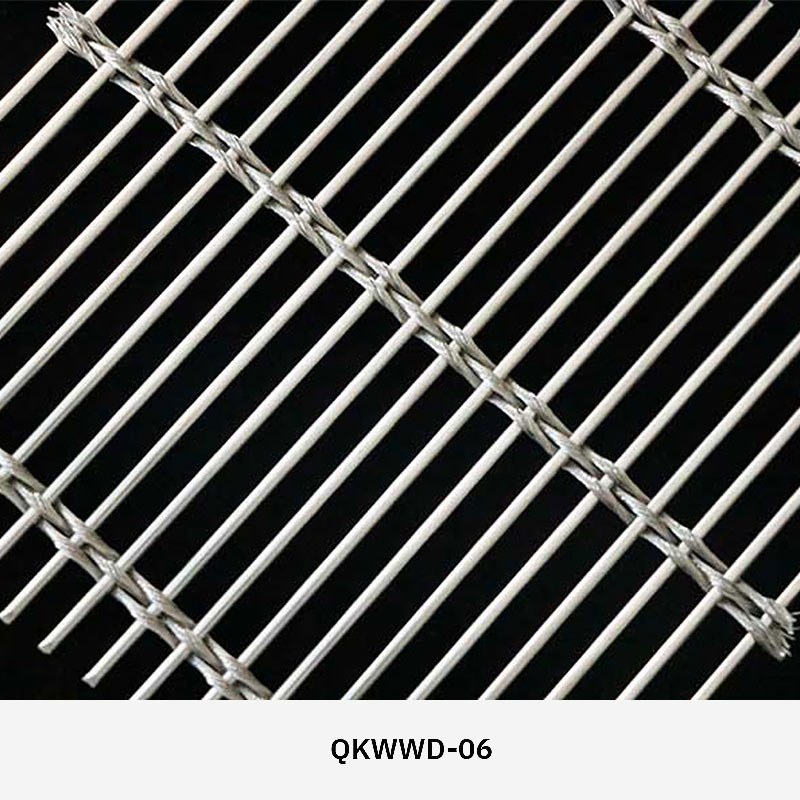 Woven wire drapery curtain panel made of decorative metal mesh used as a modern room divider or wall covering in architectural design.