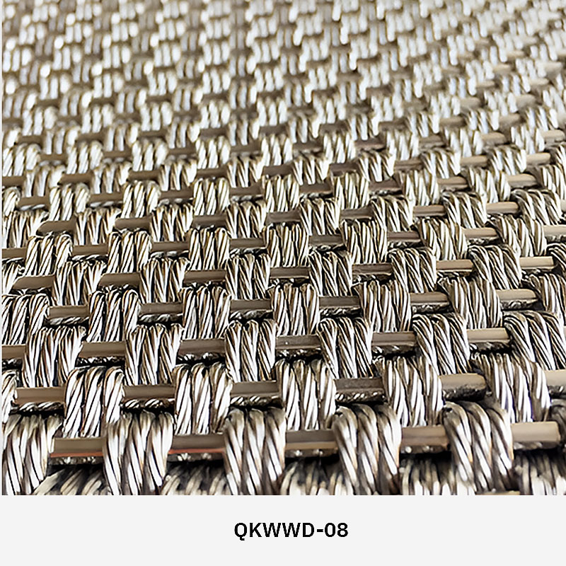 Woven wire drapery curtain panel made of decorative metal mesh used as a modern room divider or wall covering in architectural design.