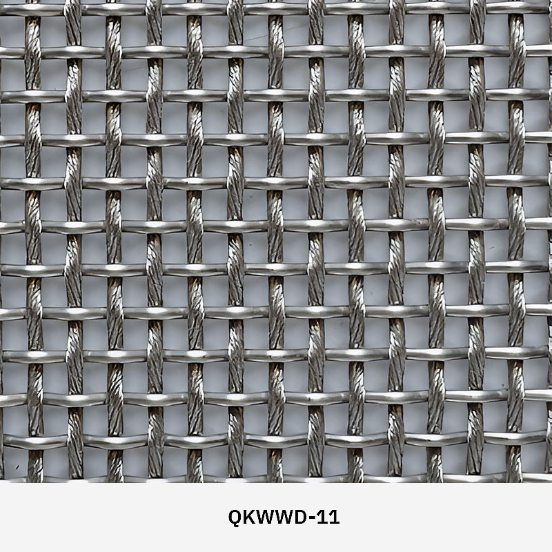 Woven wire drapery curtain panel made of decorative metal mesh used as a modern room divider or wall covering in architectural design.