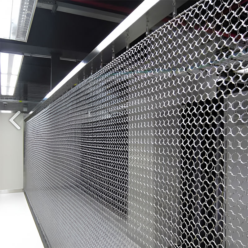 Decorion QKRMC decorative stainless steel ring mesh curtain used as a modern room divider in a commercial interior setting.