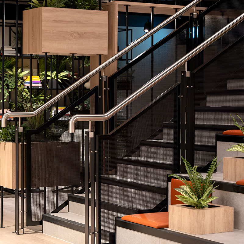 FibraMetis architectural mesh drapery showcased as interior wall cladding, highlighting custom woven metal fabric in a sophisticated interior setting.