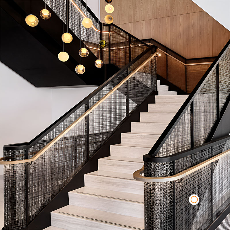FibraMetis architectural mesh drapery showcased as interior wall cladding, highlighting custom woven metal fabric in a sophisticated interior setting.