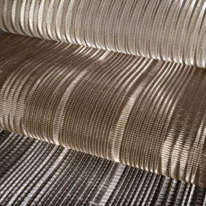 FibraMetis QKDB interior metal drapery used as a decorative wall panel, featuring woven wire fabric in custom colors and patterns