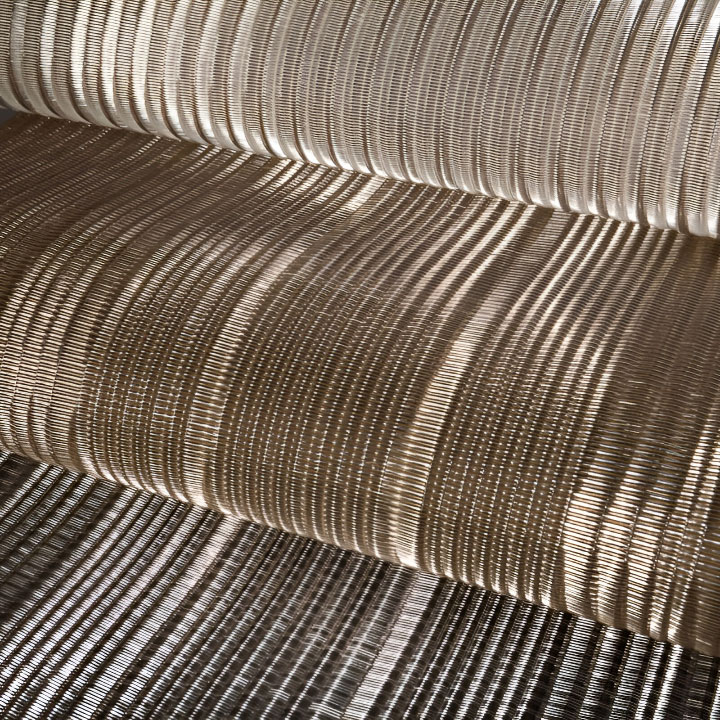 FibraMetis QKDB interior metal drapery used as a decorative wall panel, featuring woven wire fabric in custom colors and patterns
