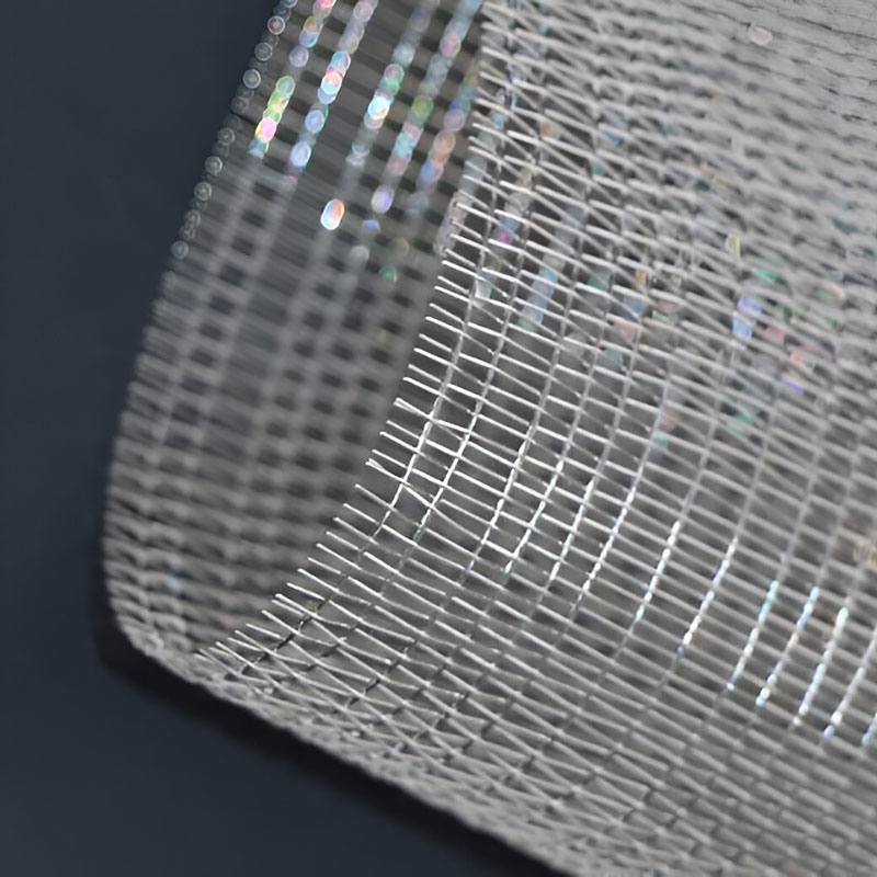 FibraMetis QKDBX decorative wire drapery installed as a modern wall panel, featuring custom woven metal mesh in silver finish