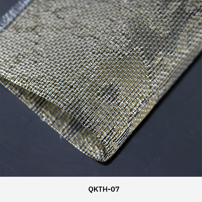 FibraMetis QKTH architectural mesh drapery used as interior wall cladding, featuring custom woven metal fabric with elegant metallic finishes.