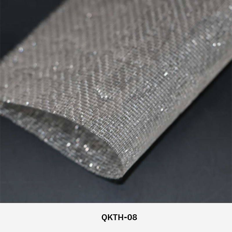 FibraMetis QKTH architectural mesh drapery used as interior wall cladding, featuring custom woven metal fabric with elegant metallic finishes.