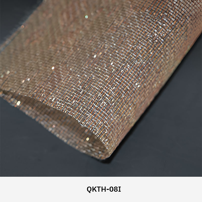 FibraMetis QKTH architectural mesh drapery used as interior wall cladding, featuring custom woven metal fabric with elegant metallic finishes.