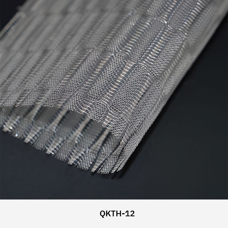 FibraMetis QKTH architectural mesh drapery used as interior wall cladding, featuring custom woven metal fabric with elegant metallic finishes.