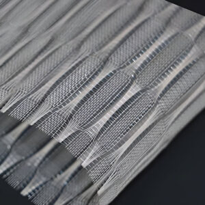 FibraMetis QKTH architectural mesh drapery used as interior wall cladding, featuring custom woven metal fabric in silver and bronze finishes
