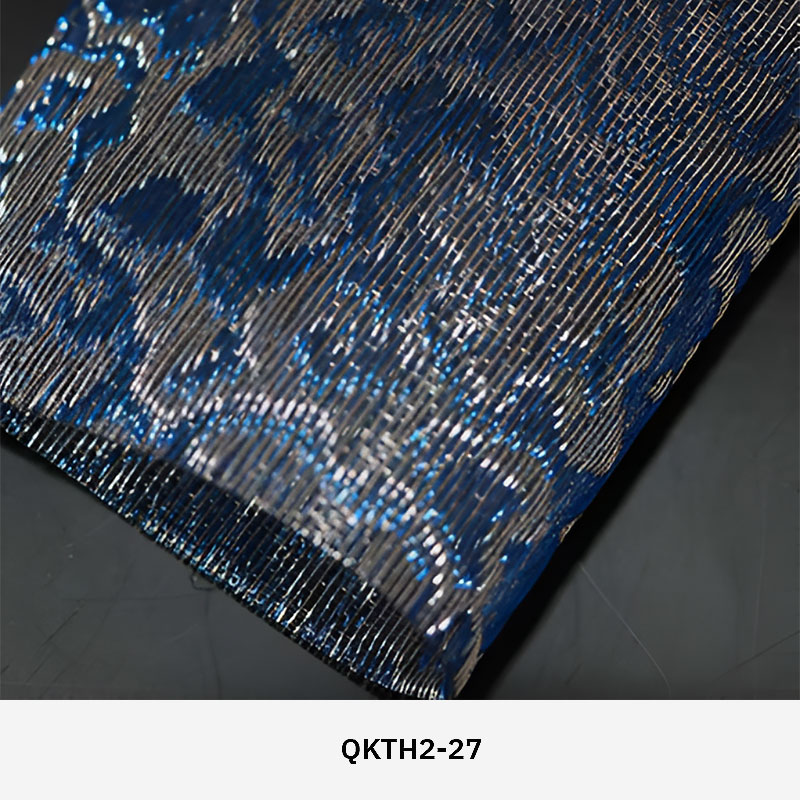 FibraMetis QKTH2 decorative wire textile applied on interior wall panels, featuring custom woven metal mesh with refined metallic finishes.