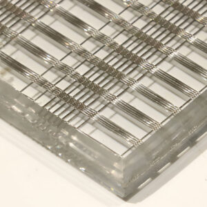 GlasMetis QKGWWD laminated glass panel with embedded woven wire mesh in a custom finish for architectural interiors