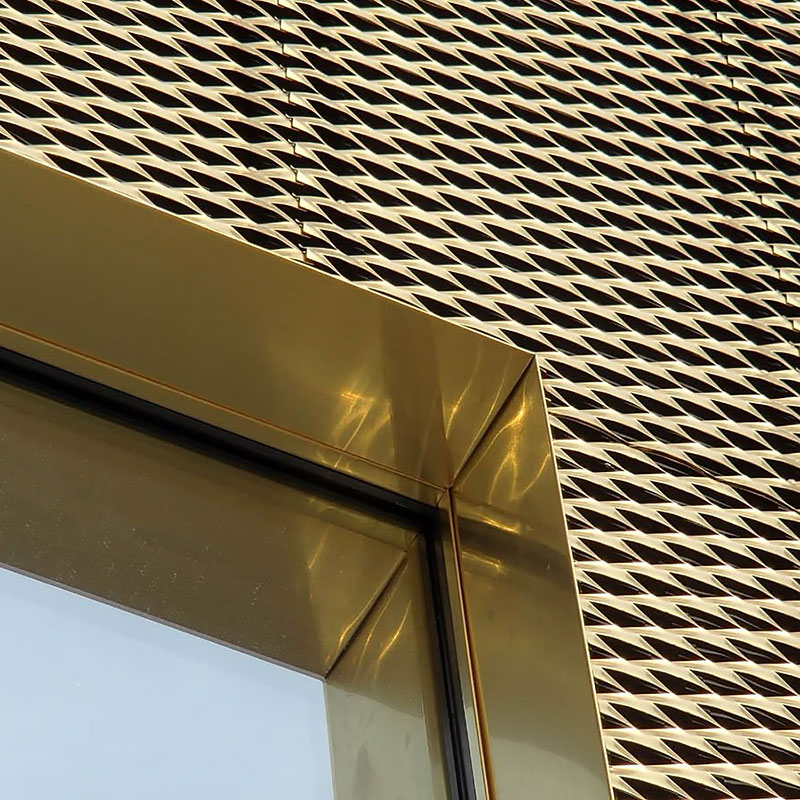 Expanded metal mesh panel with diamond-shaped openings used as architectural partition and facade feature.