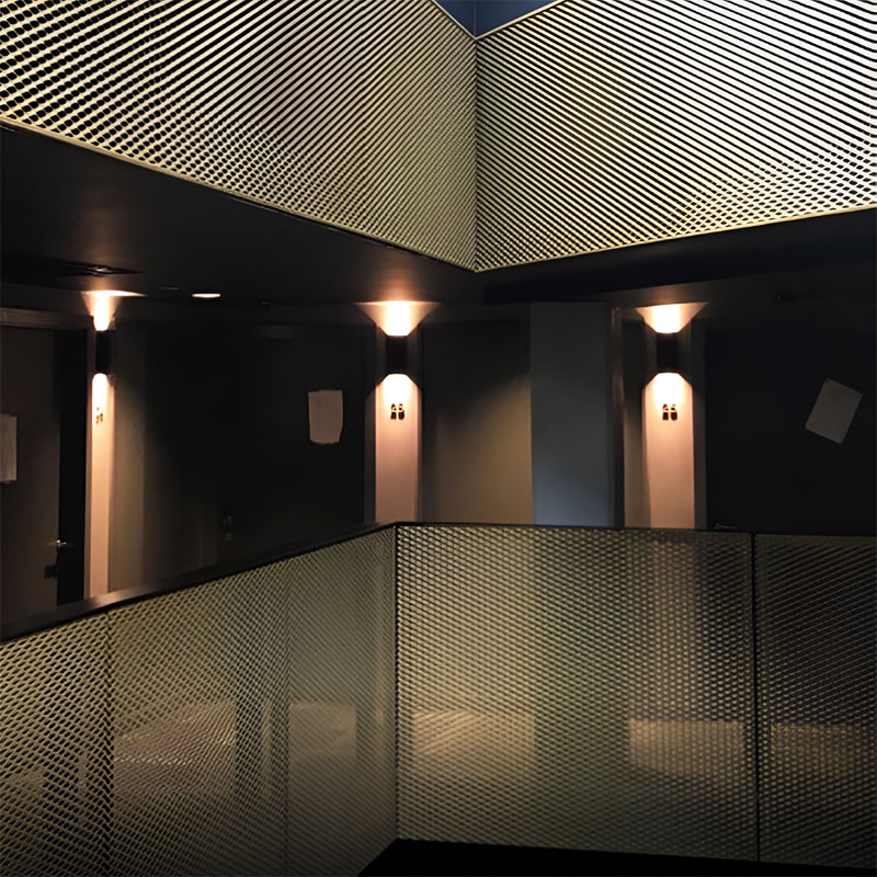 Expanded metal mesh panel with diamond-shaped openings used as architectural partition and facade feature.