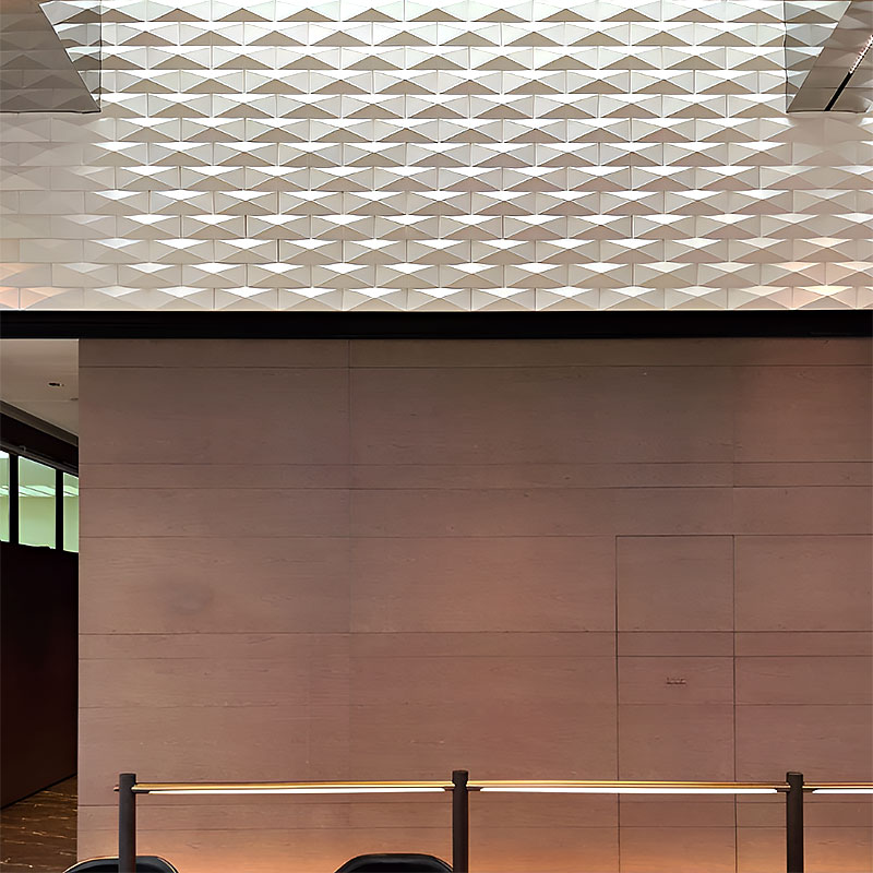 Geometric 3D wall tile with triangular pattern in matte and metallic finish, ideal for residential and commercial interior feature walls.