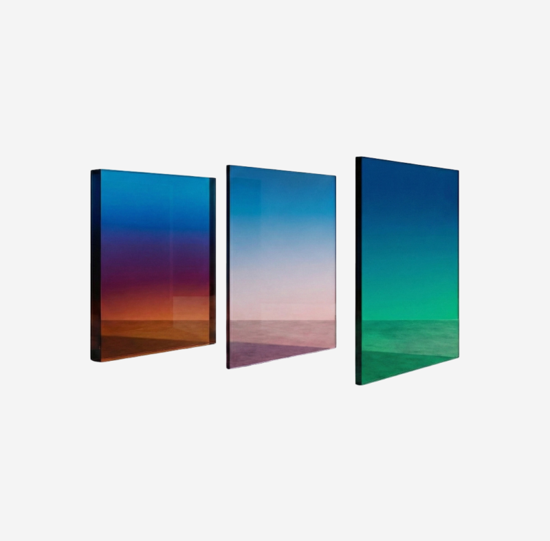 Custom gradient decorative glass panel with smooth surface and shifting color effect installed on a modern interior wall