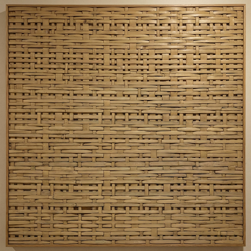 Dense irregular 3D woven synthetic rattan wall panel in HDPE for luxury interior wall cladding and partitions.